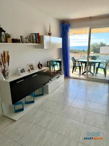 a kitchen with a table and a dining room at APARTBEACH LA CALETA CLIMA y VISTAS CALA CRANCS in Salou