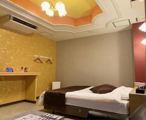 a bedroom with a bed in a room at HOTEL TWO in ONE Hiroshima-AdultOnly in Hiroshima