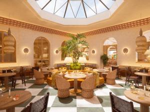 a restaurant with tables and chairs and a skylight at Hôtel Maison Chiberta I Ouverture été 2025 in Anglet