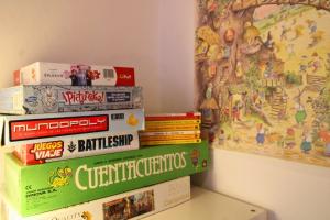 a stack of books sitting on top of a shelf at La Casa Noble in Jabugo +20 photos