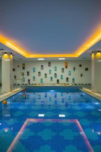 una piscina en un hotel con techo azul en ELIVAAS BYDM The Ganges 2 BHK Glasshouse Villa With Pvt Pool & Lift, en Rishīkesh