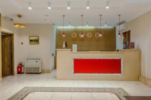 a large room with a red counter in the middle at Infinity Plaza Hotel in Atyraū