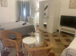 a bedroom with a bed and a table and chairs at Antica Dimora Rooms in Albisola Superiore