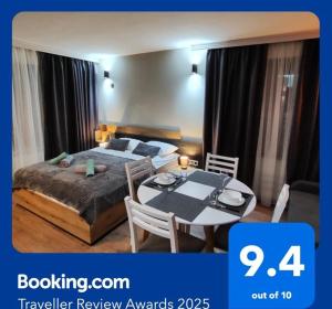 a bedroom with a bed and a table with a dining room at View apartment #2 in Bansko