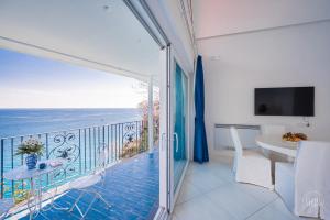 a room with a balcony with a view of the ocean at Villa Blue Sea Amalfi by Elite Villas in Ravello