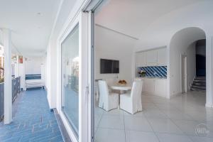 a white room with a table and chairs in it at Villa Blue Sea Amalfi by Elite Villas in Ravello +36 photos