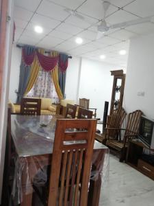 a dining room with a table and chairs and a room with at Villa Cliffside in Kosgoda +13 photos