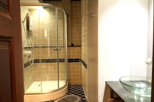 a shower with a glass door in a bathroom at Baan Kieng Guest House Lampang in Lampang +22 photos