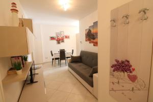 a living room with a couch and a table at Casa Francesca Otranto Modern 3 Guest Flat with AC & WiFi in Otranto