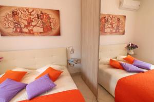 a bedroom with two beds and a mirror at Casa Francesca Otranto Modern 3 Guest Flat with AC & WiFi in Otranto +24 photos