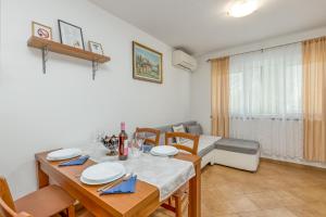 a dining room with a table and chairs and a room with at House In The Vineyard - Happy Rentals in Ankaran