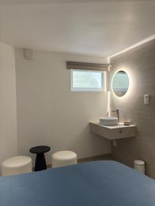 a bathroom with a sink and a counter with a window at Chez manu in Voellerdingen +49 photos