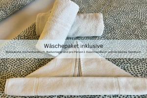 a pair of white towels sitting on top of a table at Appartementhaus Sonnenschein - 250m zum Strand im Zentrum von Binz in Binz +19 photos