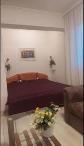 a bedroom with a bed and a glass coffee table at Rooftop Panorama Apartment in Budapest