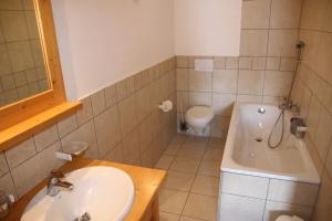 a bathroom with a sink and a tub and a toilet at Plein Ciel VA 031 - MOUNTAIN apartment 8 pers in Veysonnaz +24 photos