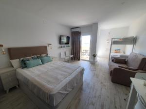 a bedroom with a large bed and a couch at Benalbeach Playa in Benalmádena