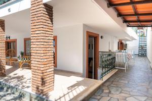 an external view of a house with a brick pillar at Salamis Blue Retreat -a seafront family apartment in Áyios Yeóryios +25 photos