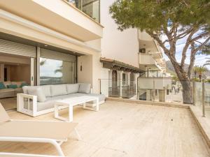 a living room with a couch and a table at Apartment Colorado 1A By SunVillas Mallorca in Port de Pollensa