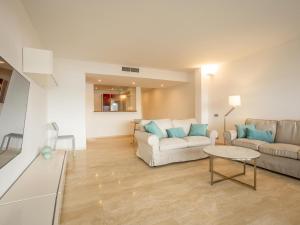 a living room with two couches and a table at Apartment Colorado 1A By SunVillas Mallorca in Port de Pollensa