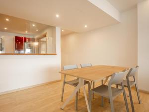 a dining room with a wooden table and chairs at Apartment Colorado 1A By SunVillas Mallorca in Port de Pollensa +19 photos