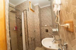 a bathroom with a shower and a sink at Oscar Apartment ! 1 ! in Luxor +17 photos