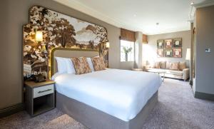 a bedroom with a large bed and a living room at Cedar Court Hotel Harrogate in Harrogate +50 photos