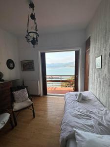 a bedroom with a bed and a view of the ocean at 4BR by the Sea, Family friendly, Breathtaking View in Avia