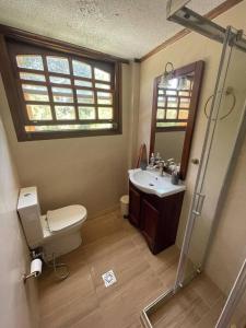 a bathroom with a sink and a toilet and a mirror at 4BR by the Sea, Family friendly, Breathtaking View in Avia