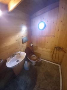 a bathroom with a toilet and a sink and a window at 4BR by the Sea, Family friendly, Breathtaking View in Avia +32 photos