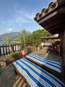 a pair of beds on a patio with a view of the water at 4BR by the Sea, Family friendly, Breathtaking View in Avia