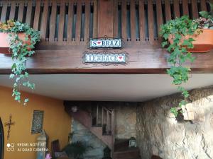 a wooden balcony with plants on a building at Casa Rústica com Piscina Privada - Perto do Porto in Landim