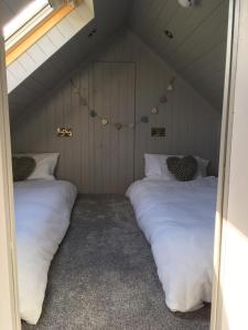 a room with two beds in a attic at Ballintoy old school house in Ballintoy