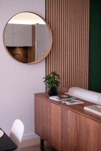 a mirror on top of a dresser in a room at La Virgule - Dole centre - Wifi - Calme in Dole +11 photos