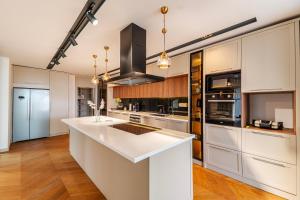 a kitchen with white cabinets and a white counter top at 5-Bedroom Villa with Pool & Sauna in Dosemealti