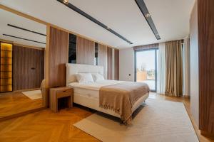 a bedroom with a bed and a large window at 5-Bedroom Villa with Pool & Sauna in Dosemealti +75 photos