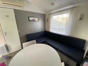 a room with a couch and a table and a window at La CABANE d'Arthur in Camiers