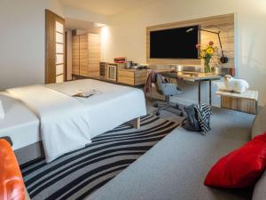 Ένα ή περισσότερα κρεβάτια σε δωμάτιο στο Novotel Wien City