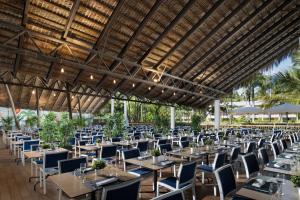 a group of tables and chairs in a restaurant at Impressive Punta Cana - All Inclusive in Punta Cana