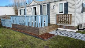 a house with a blue fence in the yard at seacottage7008 in Knokke-Heist