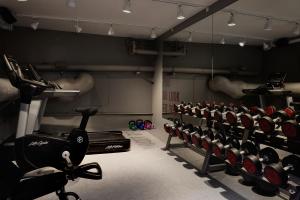 a gym with rows of exercise bikes and weights at Boutique Hotel Danmark in Copenhagen