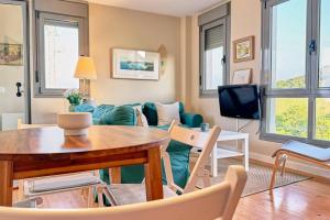 a living room with a couch and a table at Lblab11A La Brana in San Vicente de la Barquera