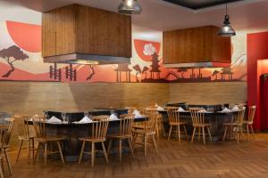 a restaurant with tables and chairs in a room at Impressive Punta Cana - All Inclusive in Punta Cana