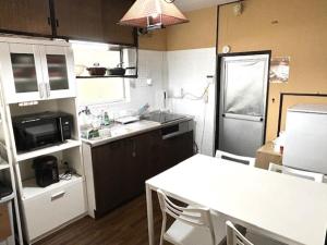 a small kitchen with a table and a refrigerator at ポートサイドSasebo泉町 in Sasebo +46 photos