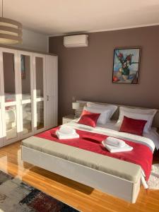 une chambre avec un grand lit avec des oreillers rouges dans l'établissement Vila Hera Korčula, Special one, pool, right on the sea,parking, 8 people, à Čara