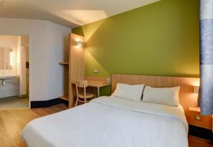 a hotel room with a bed and a desk at B&B HOTEL Paray-le-Monial in Paray-le-Monial