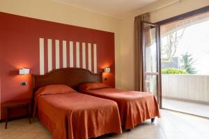 Postel nebo postele na pokoji v ubytování Hotel mariuccia