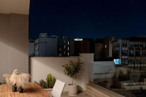 a room with a view of a city at night at Athens Soho Lofts -Evaggelistrias 18 in Athens