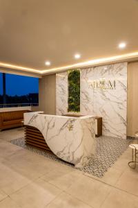 a lobby of a hotel with a marble wall at Atrium Hotel By Bestinn Leisure in Bengaluru