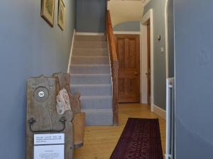 a hallway with a staircase and a stair case at Shorley Lodge in Keswick