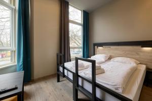 Postel nebo postele na pokoji v ubytování a&o Rotterdam City